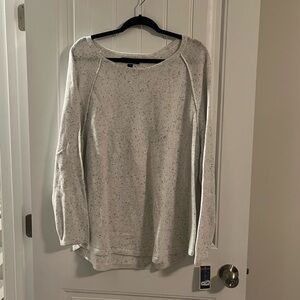 White flecked sweater with curved hem